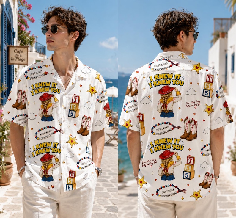 May include: A white short-sleeved button-down shirt featuring a repeating graphic print of a cowgirl, cowboy boots, yellow sheriff stars, alphabet blocks labeled T, S, 5, and the text I KNEW IT I KNEW YOU with a collar and front buttons.