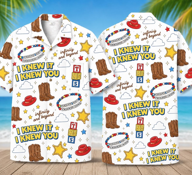 May include: A white short-sleeve button-down shirt featuring a repeating pattern of brown cowboy boots, red hats, yellow stars, white clouds, alphabet blocks with the text TS5, beaded bracelets with the text YOU'VE GOT A FRIEND IN ME, and the text I KNEW IT I KNEW YOU and infinity and beyond.