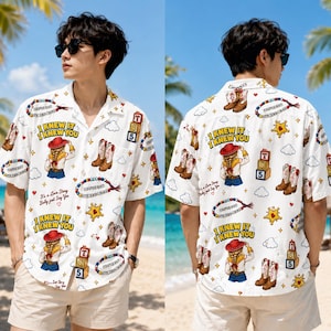 May include: A white short-sleeve button-down shirt featuring a repeating graphic print of a cowgirl, cowboy boots, star badges, alphabet blocks, and beaded necklaces. The text "I KNEW IT I KNEW YOU" and "It's a Love Story Baby just Say Yes" is printed.