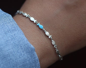 Swimming against the current silver bracelet.School of fish with one blue enameled swimming upstream. Unique jewelry for her.