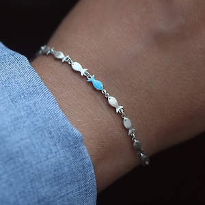 Pulsera de plata Nadando contra la corriente. Banco de peces con uno esmaltado en azul nadando contra la corriente. Joyas únicas para ella. imagen 1