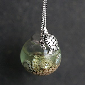 Sterling turtle sea water necklace. Turtle sitting on glass orb filled with sea water, shells and sand. Unique jewelry for her.