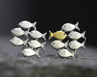 Swimming against the current. Solid sterling silver stud earrings. Mismatch. School of fish with one gold enameled swimming upstream.