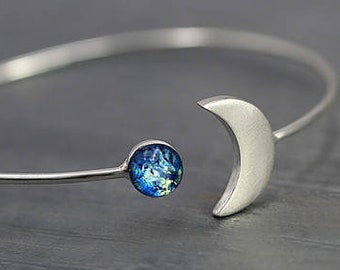 Silver MOON & EARTH bangle. Crescent moon with blue glass opal. Hand patinated silver. Adjustable.
