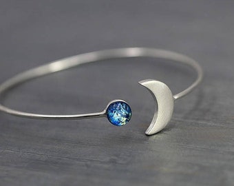 Silver MOON & EARTH bangle. Crescent moon with blue glass opal. Hand patinated silver. Adjustable.