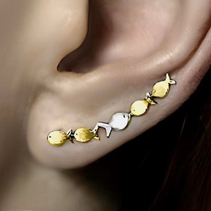 Against the current ear climbers. Dainty. Gold school of fish with one silver fish swimming upstream. Gift for her.