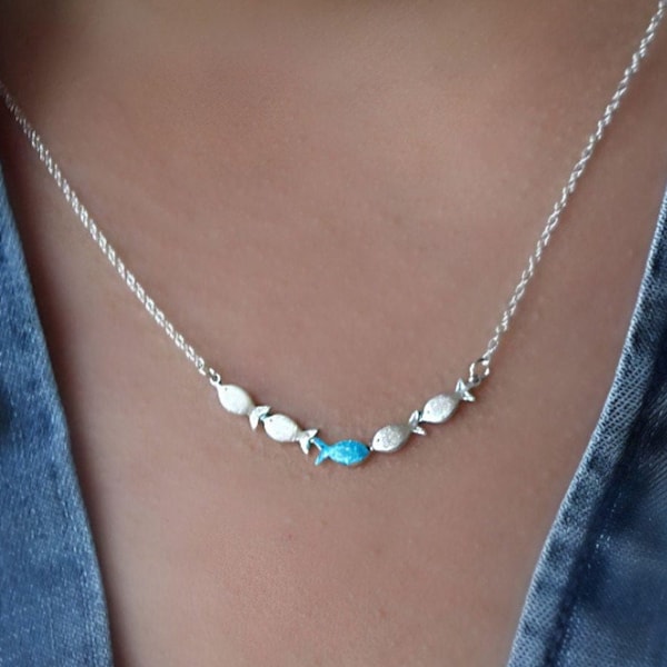 Against the current. Dainty silver necklace. Against the tide with one blue turquoise fish swimming upstream. Womens necklace.