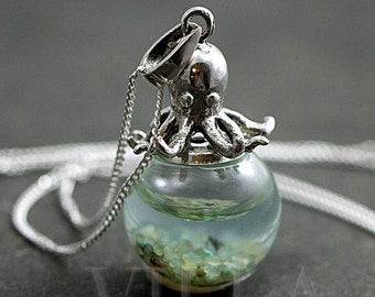 Sterling octopus seawater necklace. 925 sterling octopus carrying glass orb filled with seawater and tiny pebbles. Sterling necklace.