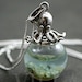 Katherine S. reviewed Sterling octopus seawater necklace. 925 sterling octopus carrying glass orb filled with seawater and tiny pebbles. Sterling necklace.