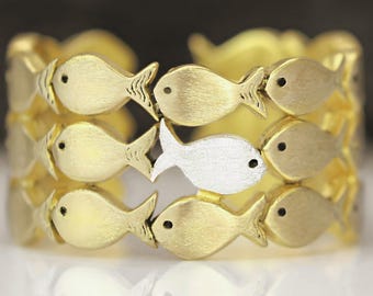 Swimming Against The Current. Sterling Gold adjustable ring. School of fish with one silver fish.