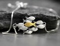 Swimming against the current silver bracelet. School of fish with one golden enameled fish swimming upstream. Gift for her.