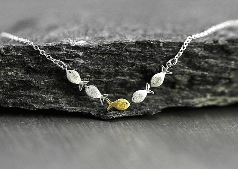 Swimming against the current. Dainty silver necklace. School of fish with one golden enameled fish swimming upstream. Gift for her. image 2