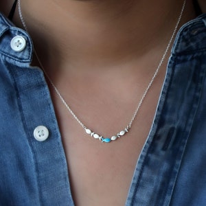 Against the current. Dainty silver necklace. Against the tide with one blue turquoise fish swimming upstream. Womens necklace. image 3