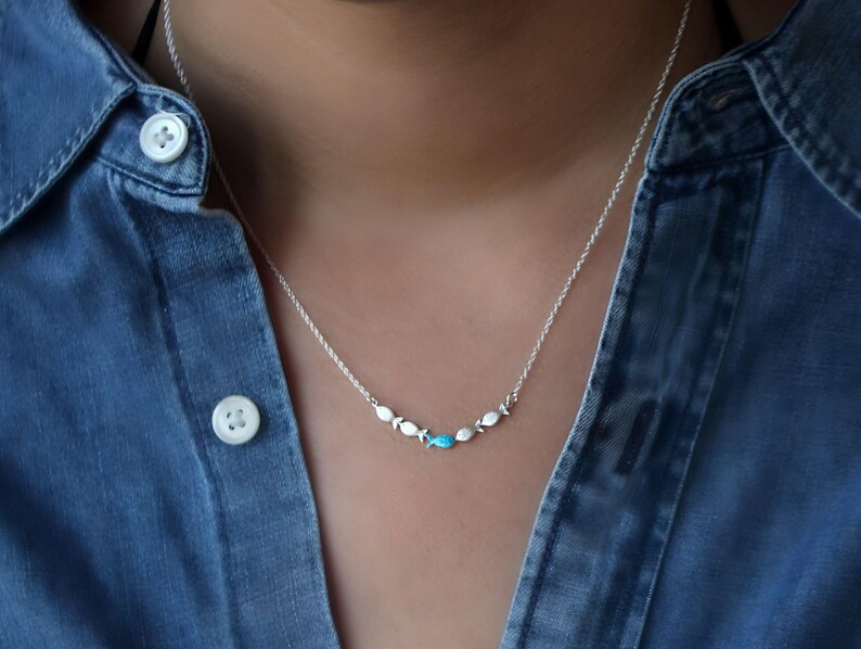 Against the current. Dainty silver necklace. Against the tide with one blue turquoise fish swimming upstream. Womens necklace. image 3