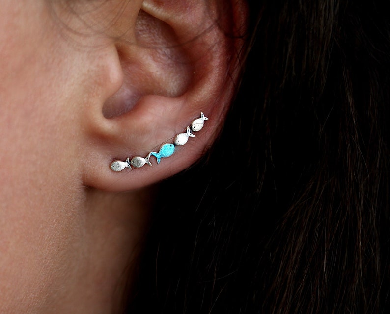 Against The Current ear climber. Against the tide with one blue turquoise fish swimming upstream. Sterling silver fish earrings. image 1