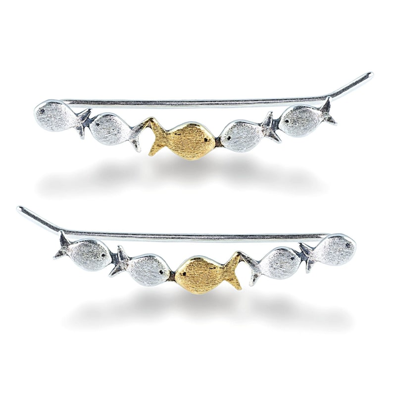 May include: A pair of silver ear climbers with a row of five fish charms. The fish charms are silver except for one gold fish charm in the center.