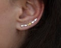 Ear climber Against The Current. Against the tide with one gold fish swimming upstream. Sterling silver fish earrings for her.