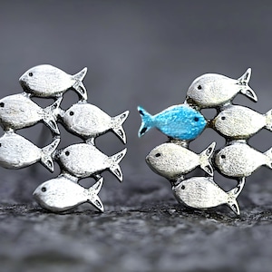 Swimming against the current. Solid sterling silver stud earrings. Mismatch. School of fish with one blue turquoise swimming upstream.