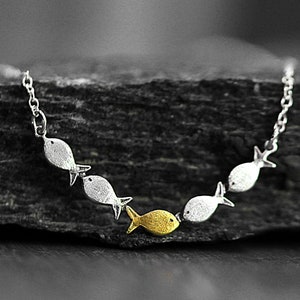 Against the current. Dainty silver necklace. Against the tide with one golden fish swimming upstream. School of fish necklace for her. image 4
