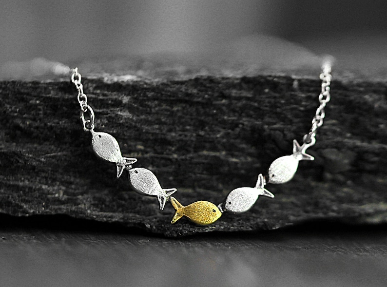 Against the current. Dainty silver necklace. Against the tide with one golden fish swimming upstream. School of fish necklace for her. image 4