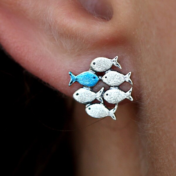 Swimming against the current. Solid sterling silver stud earrings. Mismatch. School of fish with one blue turquoise swimming upstream.