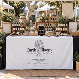 Può includere: Una tovaglia in lino bianco con il testo stampato in nero Earth & Bloom Natural Skincare, Organic Herbal Products, Small-Batch, Handmade Using Traditional Herbs & Spices, accompagnato da un'illustrazione botanica di fiori ed erbe.