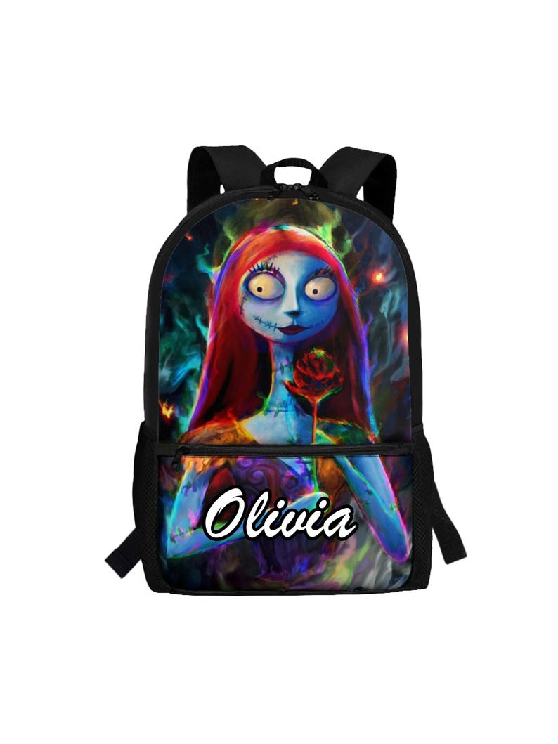 May include: A black backpack featuring a colorful graphic of a blue-skinned character with long red hair holding a red rose. The character has visible stitches on the face and neck. The name Olivia is printed in white script on the front pocket.