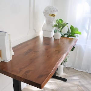 An elegant, natural wood live edge desk with unique, stand-up design, showcasing the raw, organic beauty of the wood's natural edge and texture, offering a functional and stylish workspace solution.