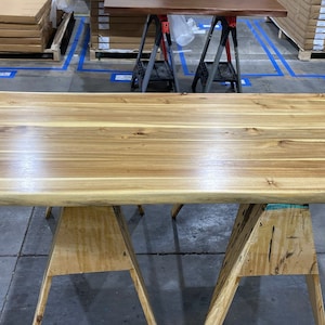 Stylish live edge desk made from rich teak wood.