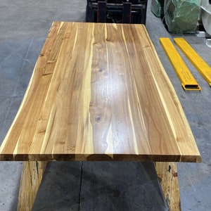 Stylish live edge desk made from rich teak wood.