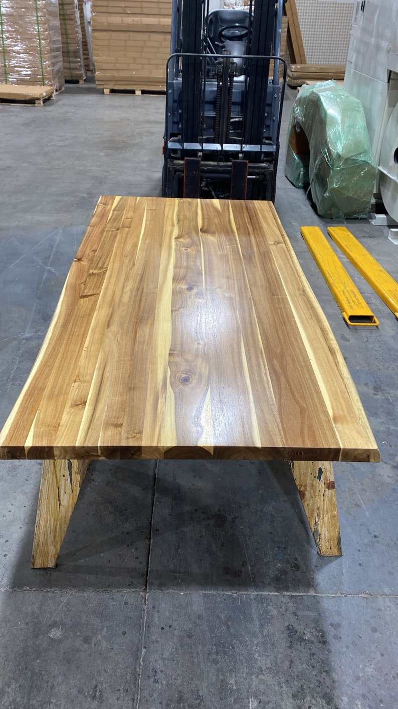 Stylish live edge desk made from rich teak wood.