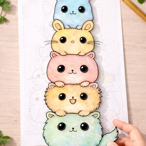 May include: A colorful illustration of five stacked, cartoon-style bunnies. Each bunny is a different pastel color: blue, yellow, pink, peach, and green. They have large, black eyes and small noses. The image is on white paper.