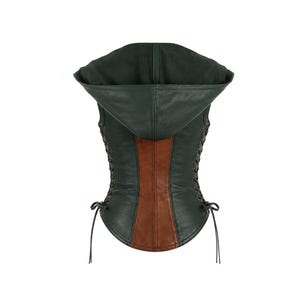 May include: A sleeveless hooded vest featuring a dark green exterior with a central vertical brown panel. The garment includes side lacing details with thin cords tied at the bottom hem, providing an adjustable fit along the torso sides.