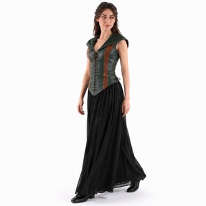 May include: A sleeveless bodice featuring a dark green and brown color scheme with a front lace-up closure and a pointed hemline, paired with a long, flowing black skirt that reaches the floor, creating a layered ensemble with a structured top.