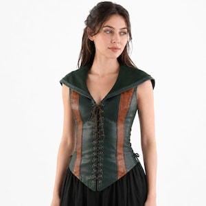 May include: A sleeveless bodice featuring a dark green and brown color scheme with a wide collar. The front includes a central lace-up closure with dark brown cord, vertical brown panels, and a pointed hemline that extends over the waist area.