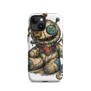 May include: A phone case with a voodoo doll illustration. The doll is beige with stitched details, a heart, and pins. It has a stitched mouth and a button eye. The case is white.