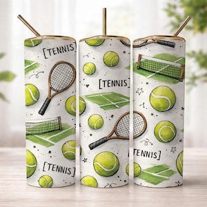 May include: A set of three stainless steel tumblers with gold-colored rims and straws. Each tumbler features a white background with a watercolor design of tennis balls, rackets, nets, and court layouts. The word "TENNIS" is printed on each tumbler.