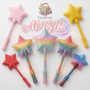 May include: A selection of star-shaped wands in shades like pink, yellow, red, and rainbow hues. The word "MAGIC" is written in a glowing style. Each wand features a handle and a star-shaped head.