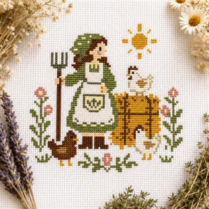 Può includere: Ricamo a punto croce raffigurante una donna con cappuccio e grembiule verdi che tiene un forcone, con galline e un sole. Il disegno comprende fiori rosa e una balla di fieno, il tutto su sfondo bianco.