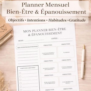Peut inclure: Un planificateur mensuel blanc avec du texte français, comprenant "Planner Mensuel Bien-être & Épanouissement" et des sections pour les objectifs, les intentions, les habitudes et la gratitude. Un stylo doré et blanc repose sur la page.