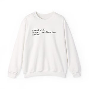 May include: A set of three ceramic mugs with a speckled, matte finish in cream, light grey, and dark grey. Each mug has a simple, minimalist design, suitable for coffee or tea.