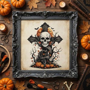 May include: A framed Halloween-themed artwork featuring a skull on a cross-shaped tree, with pumpkins and a full moon. The ornate black frame is surrounded by pumpkins, candles, fall leaves, and sewing supplies on a wooden surface.