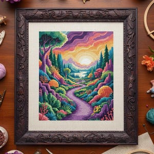 May include: A framed cross-stitch landscape depicting a sunset over a winding path through colourful trees and hills. The artwork uses a variety of colours, including purple, orange, green, and blue. The frame is dark brown.