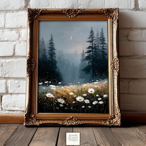 May include: A framed landscape painting featuring a forest scene with tall, dark green trees and a field of white daisies. The artwork has a gold ornate frame and a crescent moon in the sky. The painting is displayed on a wooden surface.