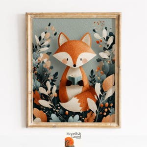 May include: A framed art print depicting a cartoon fox with orange fur, holding a small blue book. The fox is surrounded by stylized foliage in shades of green, white, and orange, set against a muted teal background. The frame is a light gold colour.