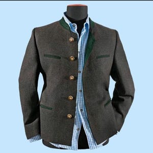 May include: A dark grey jacket with a green collar and trim, featuring gold buttons. A light blue and white checked shirt is visible underneath. The jacket is displayed on a black mannequin head against a light blue background.
