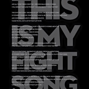 May include: Black and white poster with song lyrics from "Fight Song" by Rachel Platten. The words "This Is My Fight Song" are prominently displayed in large, gray letters, with the lyrics arranged around them.