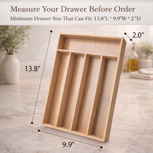 May include: A light-colored wooden drawer organizer with multiple compartments. The organizer is rectangular, measuring 13.8 inches long, 9.9 inches wide, and 2.0 inches deep. Text at the top reads "Measure Your Drawer Before Order".
