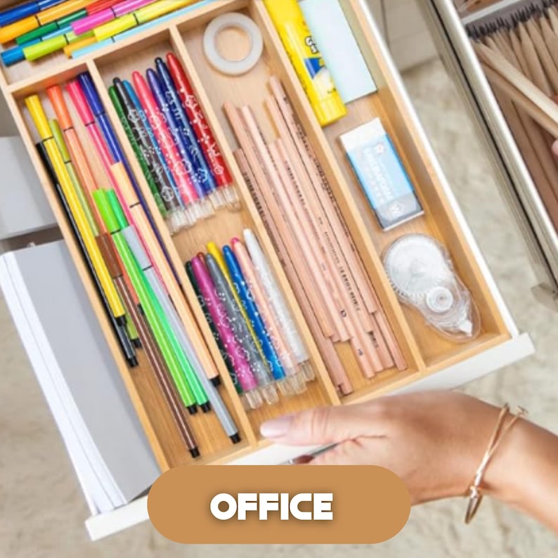 May include: A wooden drawer organizer filled with colorful pens, pencils, a glue stick, tape, and an eraser. The word "OFFICE" is displayed on a brown oval at the bottom of the image. The drawer is open, revealing the contents.