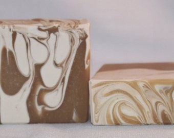May include: Two bars of handmade soap with a brown and white marbled design.